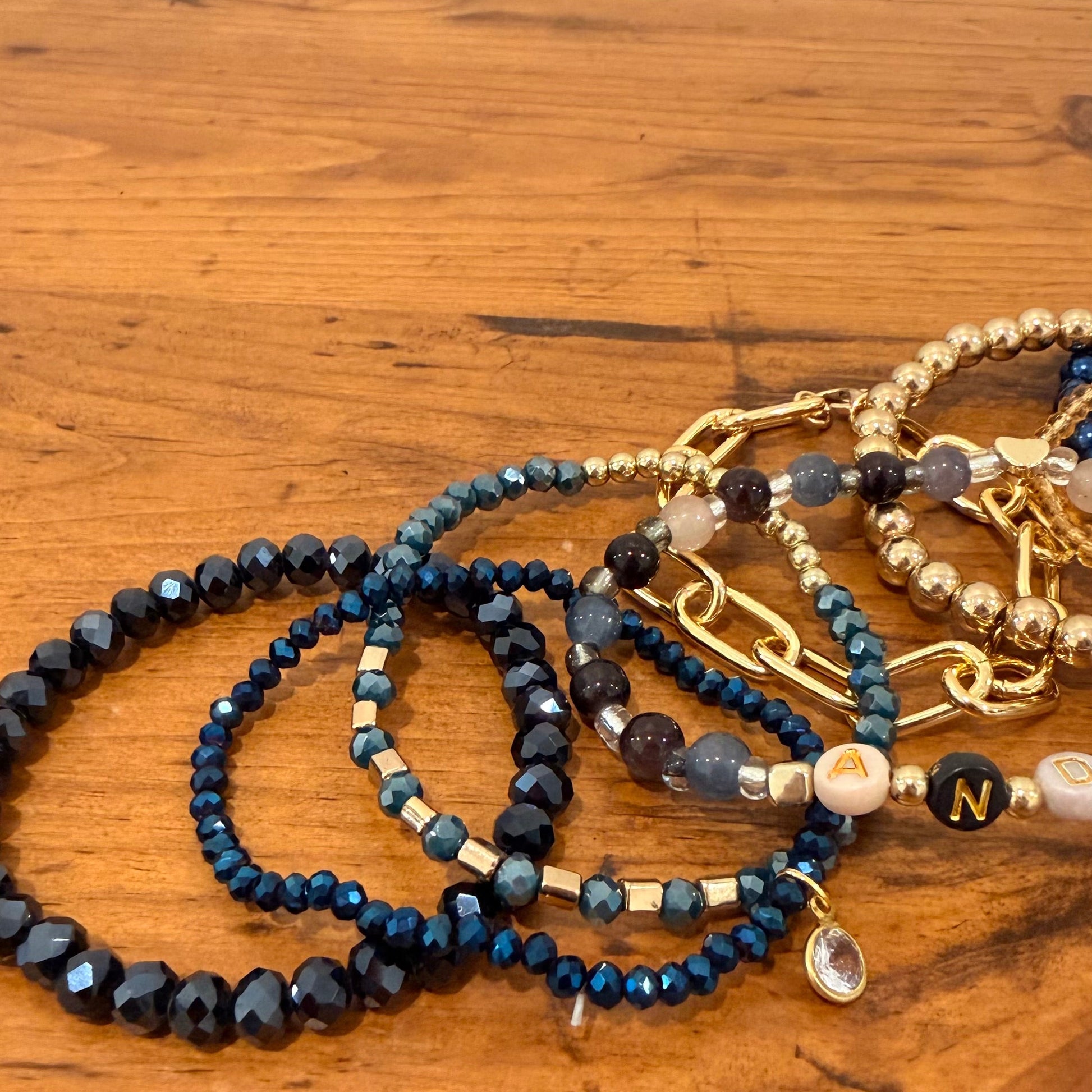 Set of beaded bracelets on a wooden surface