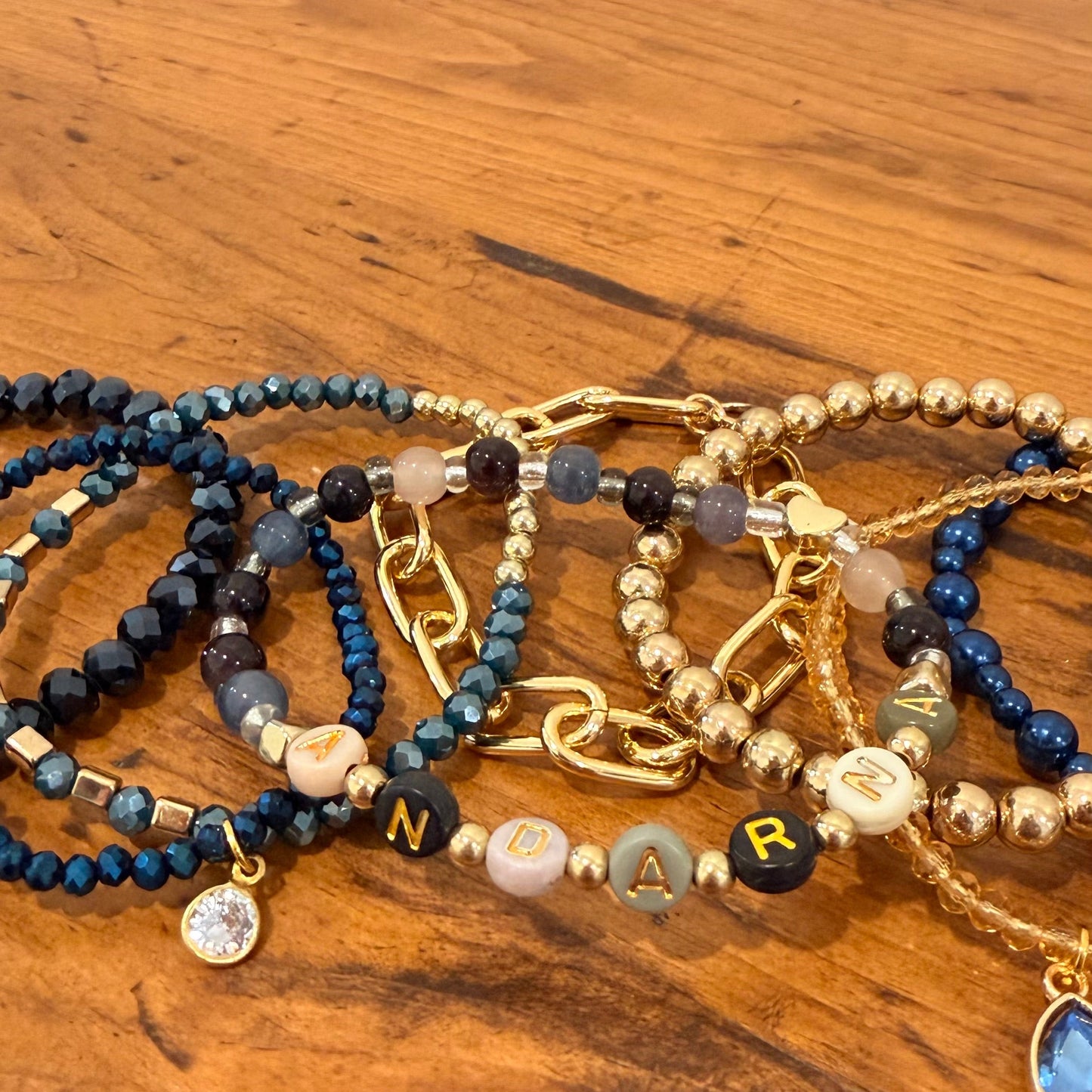 Set of beaded bracelets on a wooden surface