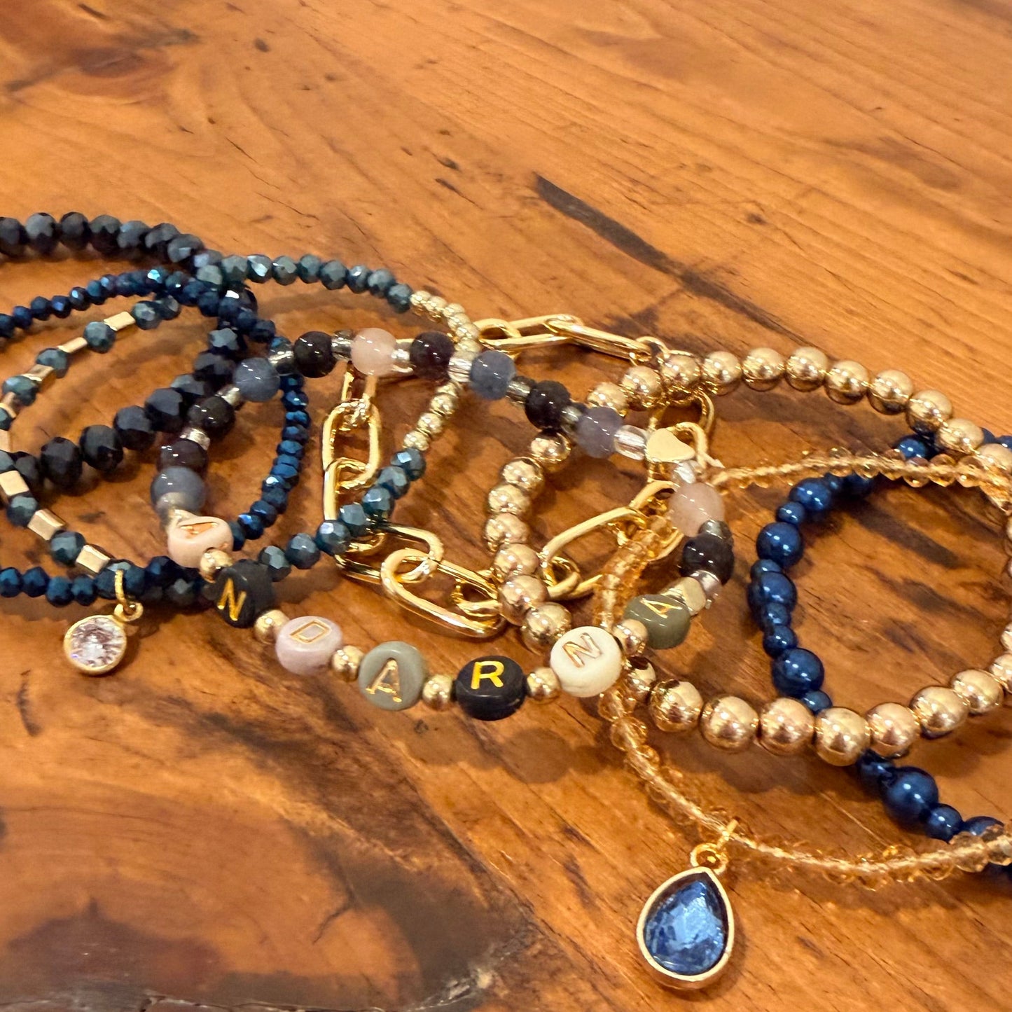 Set of beaded bracelets on a wooden surface